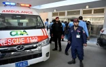 Des agents de sécurité se tiennent près d'une ambulance après un incendie à l'hôpital PIMS, à Islamabad, qui a coûté la vie à 14 nourrissons, le 26 août 2026.
