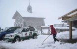 Une personne déblaie la neige au col des Aravis, près de la Clusaz, après de fortes chutes de neige, le 17 avril 2025 en Haute-Savoie