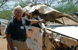 Le militant de la cause animale Iain Douglas-Hamilton pose près d'un véhicule détruit par un éléphant dans la réserve de Samburu, au Kenya, le 15 septembre 2015