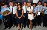 Brigitte et Emmanuel Macron avec le maire de Bormes-les-Mimosas, Francois Arizzi (G) et des gendarmes après la cérémonie à l'occasion du 75e anniversaire de la libération de la ville, le 17 août 2019