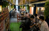 Des clients dans un wagon de train reconverti en café, le 31 mai 2021 à Phnom Penh, au Cambodge