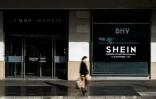Une des entrées du Bazar de l'Hotel de Ville (BHV) à Paris, le 3 novembre 2025, avec une affiche y annonçant l'ouverture d'un espace Shein pour le 5 novembre   