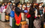 Départs de familles par train vers Shenzhen, dans le sud de la Chine, à Yichang, dans la province du Hubei qu'elles n'avaient pu quitter depuis des semaines à cause de la quarantaine, le 23 mars 2020