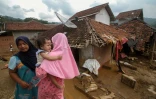 des villageois devant des maisons détruites par les inondations à Banjar Irigasi, dans la province de Banten, en Indonésie, le 2 janvier 2020