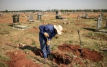 Un fossoyeur creuse une tombe au cimetière d'Avalon de Soweto, le 15 novembre 2018 à Johannesburg.