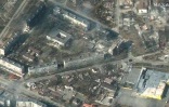 Cette photo satellite prise par la société Maxar satelitte le 18 mars 2022 montre des bâtiments d'habitation et des commerces de Marioupol (Ukraine) en flammes et très endommagés