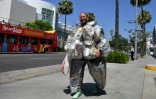 Le militant écologiste Rob Greenfield  porte les déchets qu'il a produits pendant trente jours, dans les rues de Beverly Hills, le 16 mai 2022 en Californie