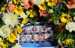 Photo prise le 7 décembre 2015 de portraits des victimes de la tuerie de San Bernardino, en Californie, sur un mémorial installé près du lieu de la fusillade