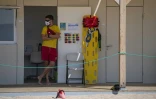 Un secouriste porte un masque de protection et surveille la plage de Lloret de Mar, le 22 juin 2020 en Espagne