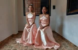 Sidneidy Uray (g) et sa demi-soeur Eikalin Gonzalez (d) dans leurs robes de "quinceaneras", le 30 juillet 2020 à Caracas, au Venezuela