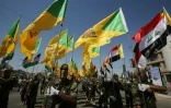 Sur cette photo d'archive, des combattants chiites irakiens des brigades du Hezbollah, groupe armé soutenu par l'Iran, défilent dans les rues de Bagdad, le 31 mai 2019