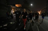 Des joggeurs de Midnight Runners dans les rues du quartier de Skid Row à Los Angeles, le 12 décembre 2016