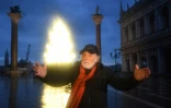 L'artiste italien Fabrizio Plessi pose devant son installation lumineuse évoquant un sapin de Noël sur la place Saint-Marc à Venise le 4 décembre 2020