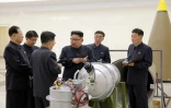 Photo fournie par l'agence officielle nord-coréenne KCNA le 3 septembre 2017 du leader nord-coréen Kim Jong-Un (c) examinant un dispositif ressemblant à une bombe H dans un endroit non précisé