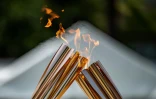 Passage de relais de la flamme olympique à Tokyo le 20 juillet 2021