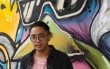 L'artiste vietnamien Dan Nguyen devant son graffiti, le 19 février 2017 à Ho Chi Minh-Ville