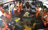 Image tirée d'une vidéo publiée par la Coalition de la flottille pour la liberté, le 9 juin 2025, montrant des militants à bord du bateau Madleen à destination de Gaza, les mains en l'air, alors qu'ils sont interceptés par les forces israéliennes dans les eaux internationales avant d'atteindre le territoire palestinien