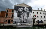 A mural by artist Maurizio Cattelan is seen outside Giudecca Women’s Prison hosting the Holy See pavilion during the pre-opening of the 60th Venice Biennale art show, on April 18, 2024 in Venice.