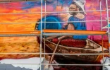 Une fresque murale de l'artiste béninois Romario Agbo-Koffi, dit Dr Mario, pendant le festival Effet Graff, le 18 mai 2022 à Cotonou, au Bénin