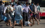 Des partisans de la junte rassemblés autour d'un homme qui a été attaqué au cours d'une manifestation à Rangoun le 25 février 2021