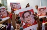Des portraits d'Aung San Suu Kyi sont brandis par des manifestants devant l'ambassade de Birmanie à Bangkok, le 7 février 2021