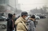 Des piétons portent des masques antipollution dans les rues de Pékin le 30 novembre 2015