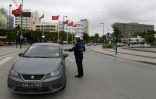 Photo d'archives montrant un policier tunisien contrôlant un véhicule le 24 mars 2020 dans la capitale Tunis