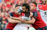L'ailier du Stade Toulousain, Yoann Huget, est plaqué par un joueur irlandais du Munster, lors de leur quart de finale de la Coupe d'Europe, le 1er avril 2017 au Thomond Park à Limerick