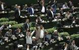 Des députés iraniens se lèvent alors que le président iranien Hassan Rohani s'exprime devant le Parlement à Téhéran, le 28 août 2018