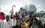 Des Soudanais célèbrent la signature d'un accord entre militaires et meneurs de la contestation à Khartoum, le 17 août 2019