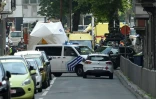 Des véhicules de police et des ambulances dépêches sur les lieux où un assaillant a tué trois personnes à Liège le 28 mai 2018 avant d'être abattu par les policiers.