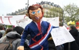 Un manifestant brandit une marionnette représentant le président français  Emmanuel Macron lors des manifestation du 1er mai 2021 à Paris
