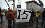 Des manifestants autour d'une banderole appelant à limiter le réchauffement de la planète à +1,5°, en marge de la COP26, à Glagow, en Ecosse