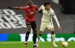 Le milieu de Manchester United Paul Pogba (g) à la lutte avec le défenseur de la Roma Chris Smalling en demi-finale aller de Ligue Europa, le 29 avril 2021 à Manchester