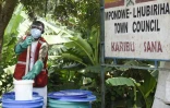 Un agent sanitaire prépare une solution de chlorine pour désinfecter au centre de santé de Mpondwe, le 13 juin 2019 en Ouganda gagné par l'épidémie d'Ebola