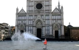 Une employé municipal désinfecte la place Santa Croce à Florence, le 21 mars 2020