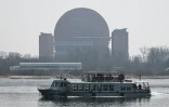 Un bateau touristique chinois sur le fleuve Yalu passe devant un hôtel de la ville nord-coréenne de Sinuiju, face à la ville frontalière de Dandong, dans le nord-est de la Chine, le 26 mars 2026
