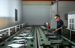 Un employé sur une ligne de production de l'usine Wosen, un fabricant d'éclairages LED, le 17 avril 2025 à Zhongshan, dans la province du Guangdong, dans le sud de la Chine