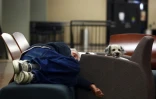 Un homme dort sur un lit de fortune, dans un refuge pour les personnes évacuées de Fort McMurray, au Canada, le 5 mai 2016