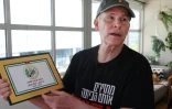 L'Israélo-américain Keith Siegel, qui a passé 484 jours en captivité à Gaza, montre un certificat de libération de ses ravisseurs lors d'un entretien avec l'AFP, le 12 juin 2025 à Tel-Aviv