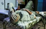 Photo d'un homme blessé et couvert de poussière dans l'hôpital de Douma, l'une des principales localités du fief rebelle dans la Ghouta orientale, en Syrie, le 3 mars 2018