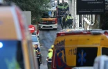 Des policiers et secouristes près du site d'un bâtiment effondré à Madrid, le 7 octobre 2025 en Espagne