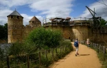 Des visiteurs parcourent le chantier du château de Guédelon, un château médiéval construit selon les méthodes du XIIIe siècle, à Trège, le 23 juin 2025 dans l'Yonne
