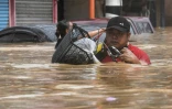 Floodwater raced through parts of Manila after huge downpours