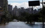 Des pompiers en bateau dans la ville inondée de Porto Alegre, dans l'Etat du Rio Grande do Sul, le 9 mai 2024 au Brésil