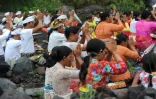 Des Balinais de confession hindoue prient près du volcan Agung, dans le village de Muntig le 26 novembre 2017, dans l'espoir d'empêcher l'éruption du volcan