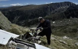 Jimmy Vial découpe à la scie à métaux une aile d'un planeur accidenté avant d'en ramener une partie à Porta, dans les Pyrénées-Orientales, plus bas dans la vallée, le 8 juin 2021