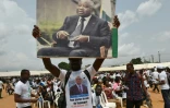 Un militant brandit un portrait de l'ancien président ivoirien Laurent Gbagbo, le 27 février 2021 à Abidjan, lors d'un meeting de campagne pour les élections législatives en Côte d'Ivoire
