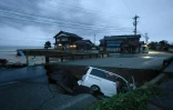 Une voiture accidentée sur une route qui s'est affaissée après de fortes pluies à Suzu, dans la préfecture d'Ishikawa, le 21 septembre 2024 au Japon