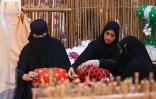 Des femmes émiraties tissent selon la méthode Al Talli, une technique de tissage locale traditionnelle, lors d'un festival à Al-Ain, aux Emirats arabes unis, le 10 novembre 2023